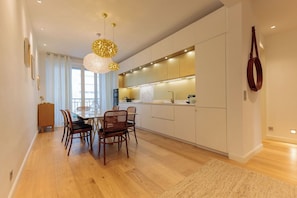 A modern kitchen with white cabinets, a central island, and pendant lighting. - Apartment in Cannes with 2 bedrooms sleeps 5 (Cannes)