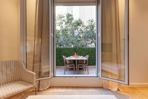 A room with a sliding glass door leading to an outdoor dining area with a table and chairs. - Apartment in Cannes with 2 bedrooms sleeps 5 (Cannes)