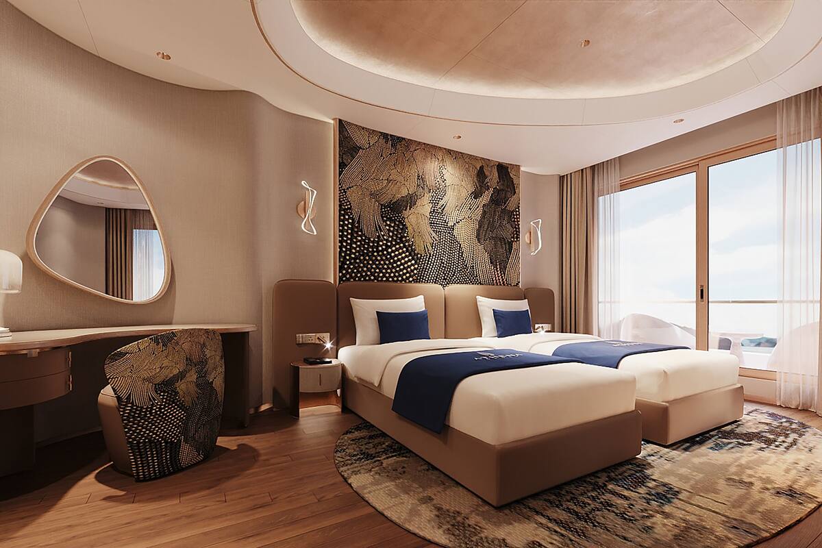A modern hotel room with a large bed, a desk, and a large window.