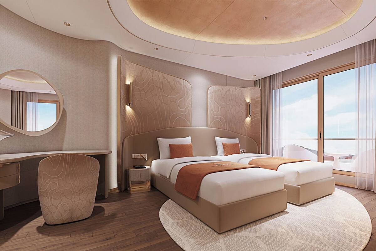 A modern hotel room with a large bed, two bedside tables, a desk, and a chair.