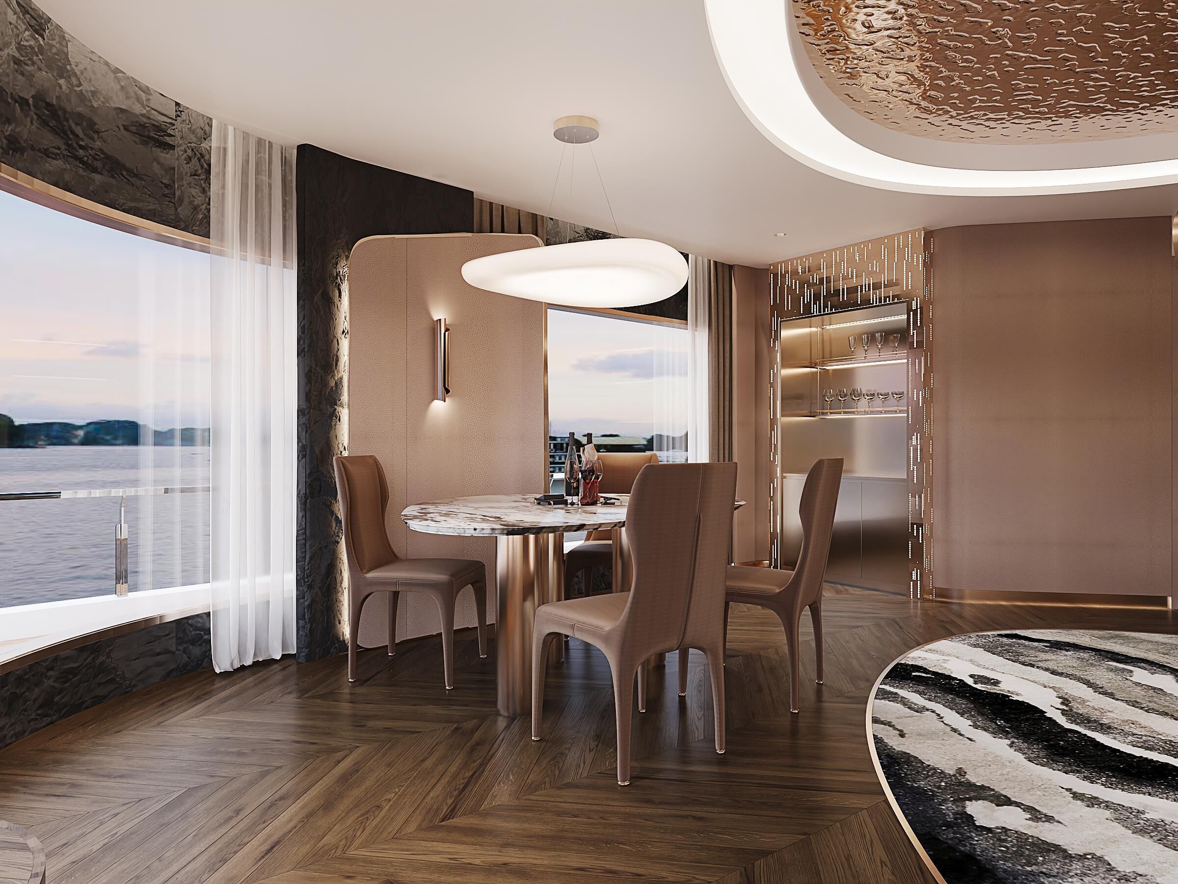 A modern dining area with a round table, chairs, and a view of the water.