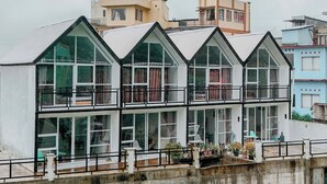 A multi-story building with large windows and balconies. - Lotus Nexura Escape (Kejajar)