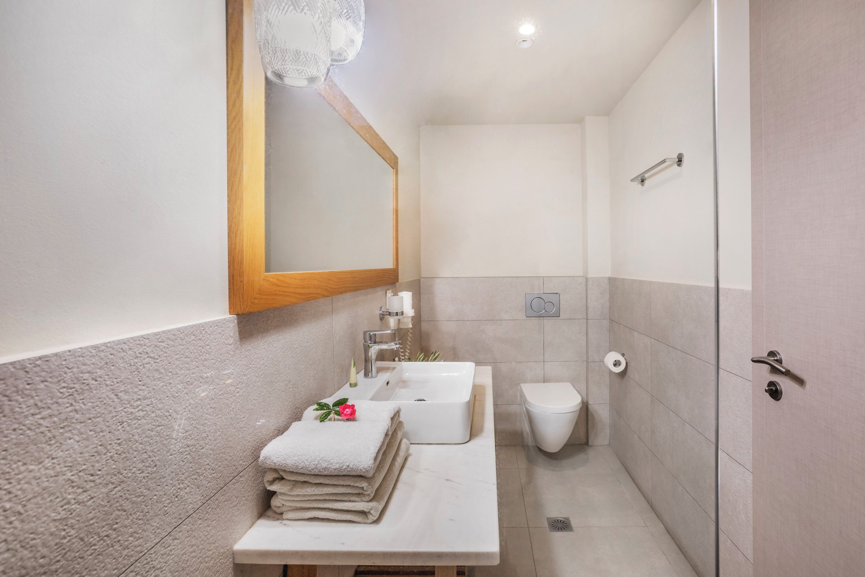 A bathroom with a sink, toilet, and shower.