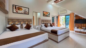 A hotel room with two beds, a TV, and a balcony with curtains. - Green Paradise Trimbak (Trimbak)