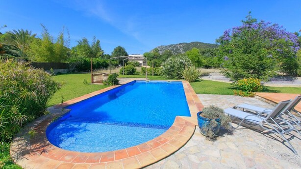 A rectangular swimming pool with a tiled edge, surrounded by a stone patio. - Charming villa in Crestatx, near Pollensa (Sa Pobla)