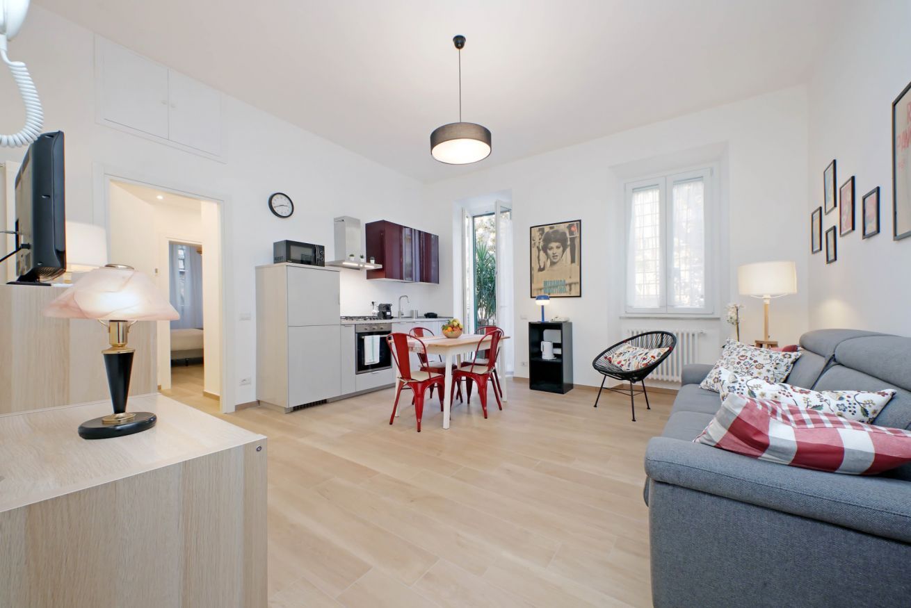 A modern apartment with a kitchen, dining area, and living room.