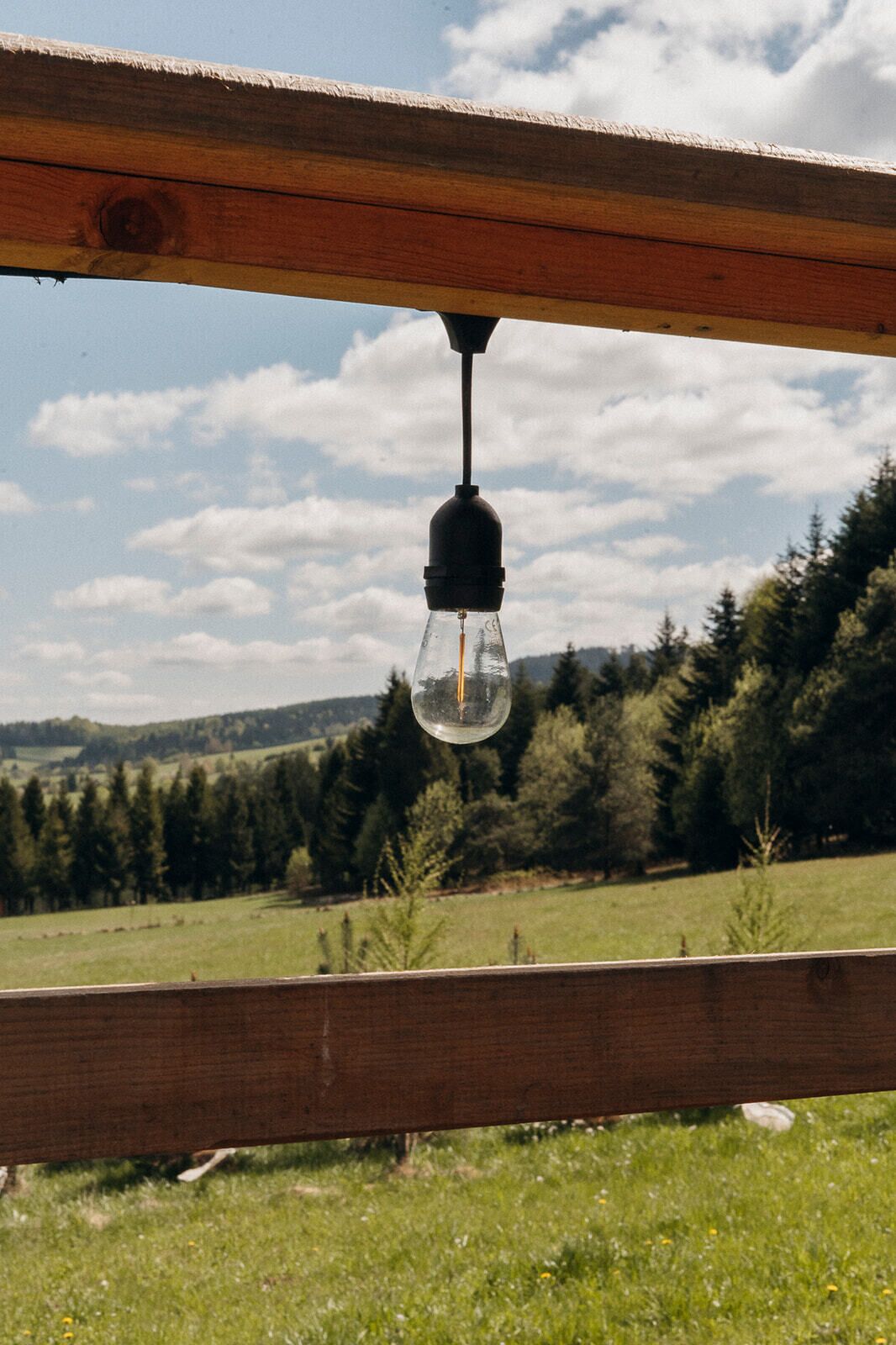 A wooden structure with a hanging light fixture.