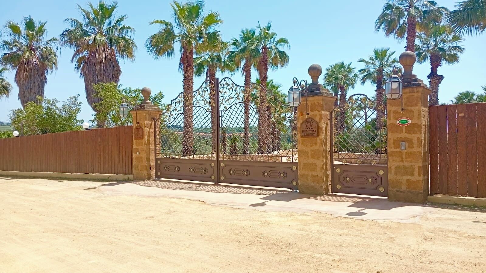 A gated entrance with a sign reading 'BEMETRA RESORT.'