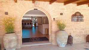 A stone archway entrance to a building with a sign reading 'DEMETRA RESORT.' - Villa Demetra Resort (Agrigento)