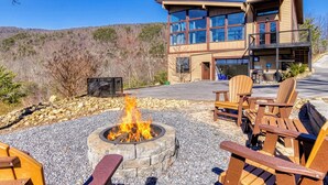 A modern building with a fire pit and outdoor seating. - Summit Trails Retreat – Indoor Pool, Home Theater, Hot Tub | Sleeps 16!!! (Sevierville)
