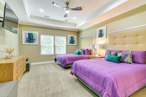 A bedroom with two beds, a wooden dresser, and artwork on the walls. - Pool Table & Fenced Yard: Home 5 Mi to NRG Stadium (Houston)
