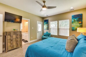 A bedroom with a bed, a ceiling fan, a TV, a dresser, and a door. - Pool Table & Fenced Yard: Home 5 Mi to NRG Stadium (Houston)