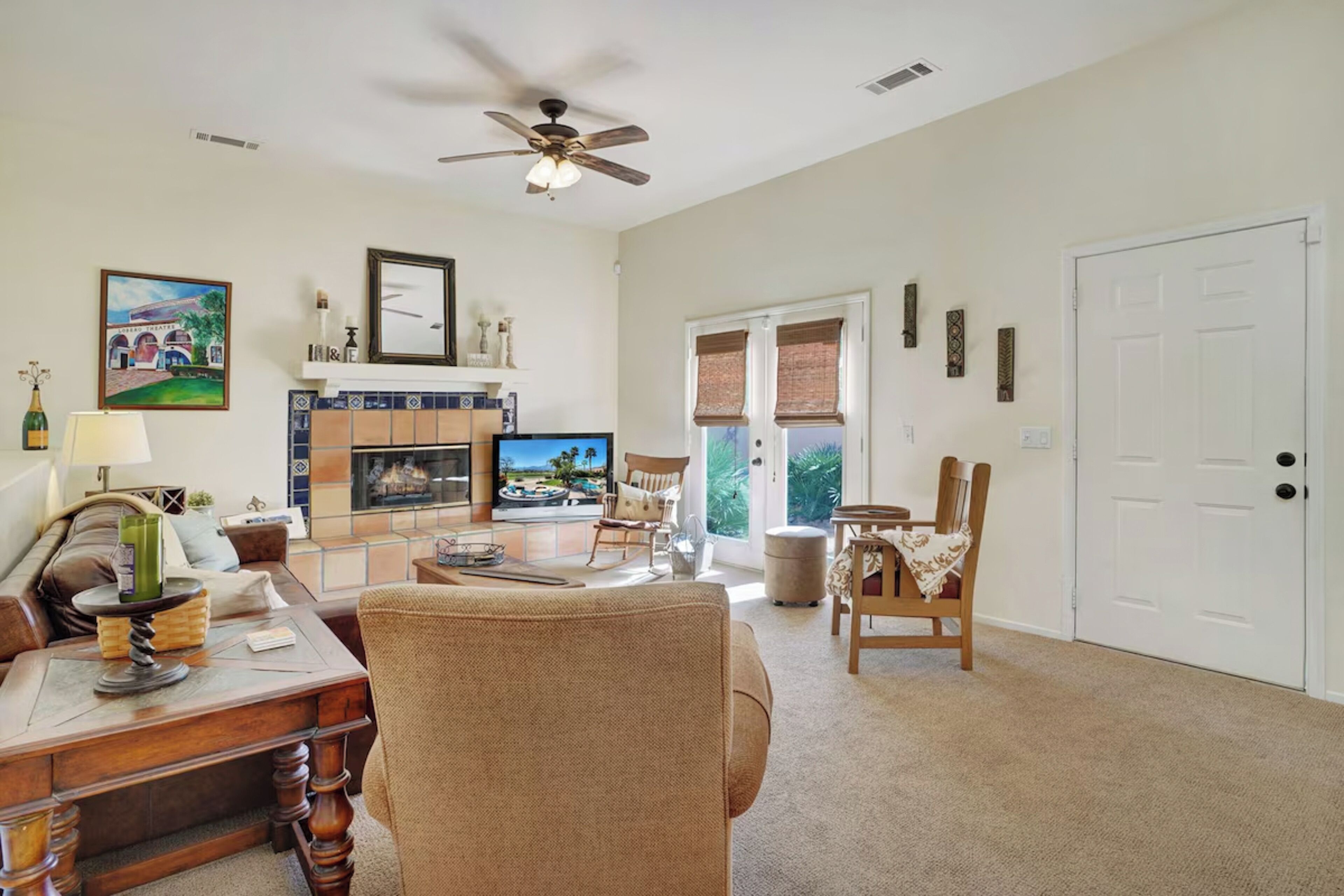 A spacious living room with a fireplace, television, and comfortable seating.