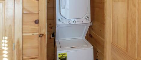 Un lave-linge et un sèche-linge blancs, dotés d’une étiquette ENERGYGUIDE, placés dans un meuble en bois.