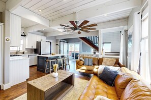 A spacious living area with a leather sofa, wooden coffee table, and a ceiling fan. - Private Hot Tub & Sauna! Midway Family Hideaway (Midway)