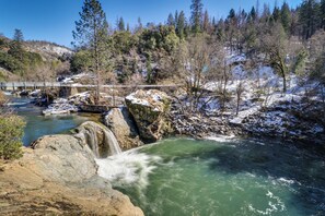 A natural landscape with a river, a waterfall, and a bridge. - 4BR Home Near Yosemite w/ Pool Table (Groveland)