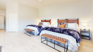 A spacious bedroom with two beds, a bench, and a nightstand. - Two Dog-friendly Home, Close to Wine Country (Fallbrook)