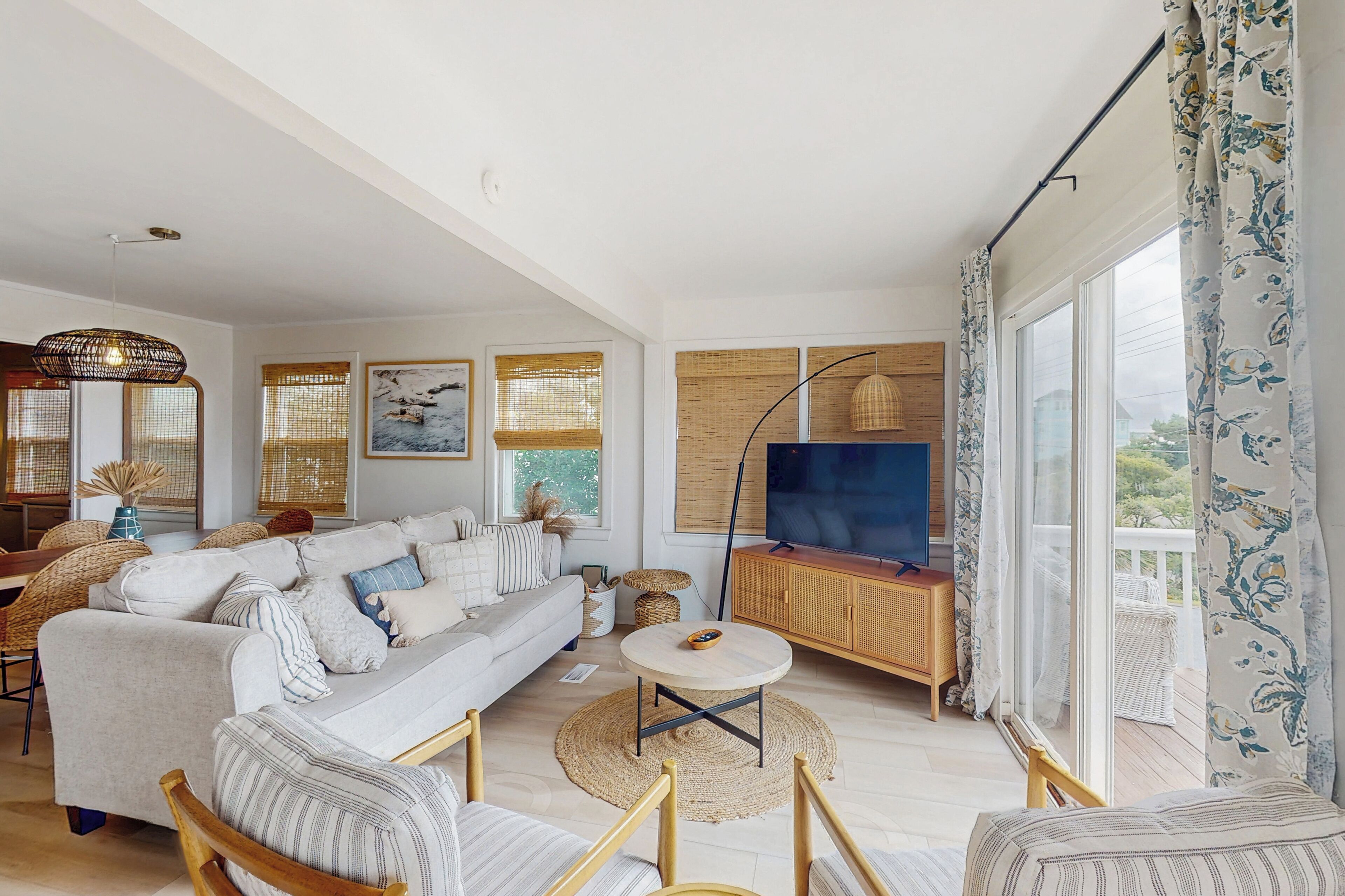 A modern living room with a sofa, coffee table, and television.