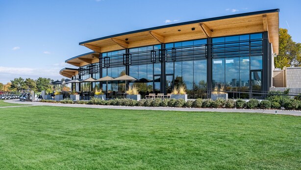 A modern building with large glass windows, outdoor seating, and a well-maintained lawn. - New Listing! Walk to City Park & Restaurants |  Extended Stays | Central AC (Denver)