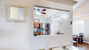A modern kitchen with white cabinets, a stainless steel refrigerator, and a ceiling fan. - Dog-friendly Yard! Retreat 11 Mi to Destin & Beach (Niceville)