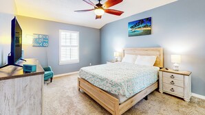 A bedroom with a bed, nightstand, desk, and a ceiling fan. - Dog-friendly Yard! Retreat 11 Mi to Destin & Beach (Niceville)
