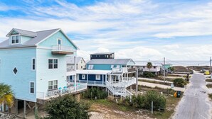 A coastal residential area with houses featuring balconies and waterfront views. - Fort Morgan beachside retreat ~ pet-friendly ~ close to the sand (Gulf Shores)