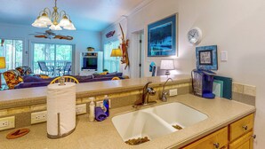A kitchen with a large sink, countertop, and a ceiling fan. - Dog-friendly Riverfront 3BR w/ Fire Pit & Dock (Bell)