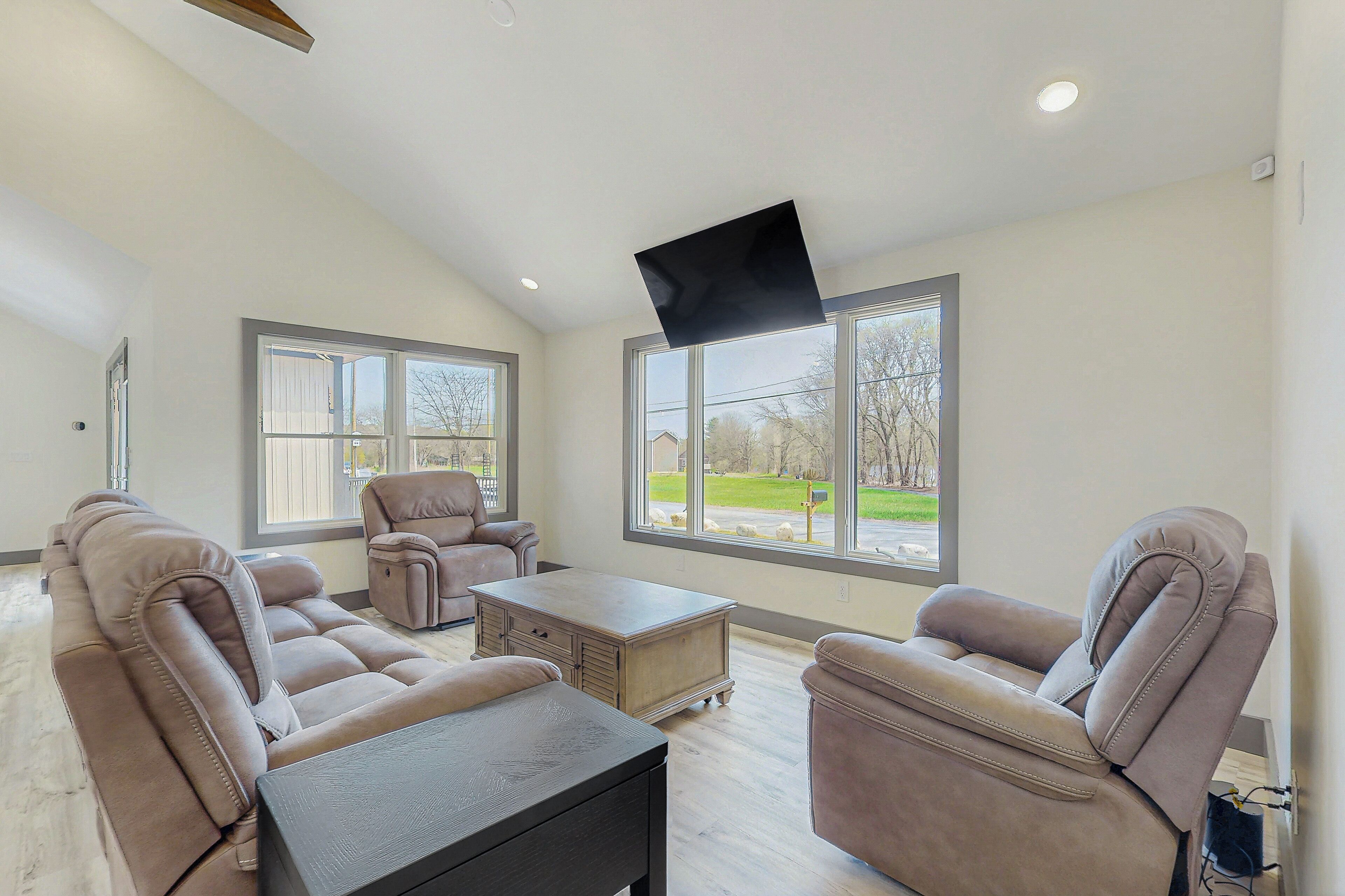 A spacious living room with a sectional sofa, a recliner, and a coffee table.