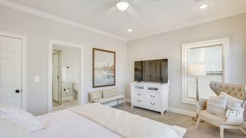 A bedroom with a bed, a dresser, a chair, a ceiling fan, and a window with blinds.