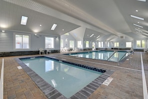 A large indoor swimming pool with multiple lanes, surrounded by lounge chairs and a high ceiling with skylights. - Spacious Home w/ Oceanside Village Resort Perks! (Murrells Inlet)