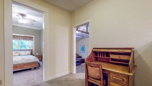 A bedroom with a bed, a wooden desk, and a chair. There is a ceiling fan above the bed and a window with curtains. - Forbestown Retreat: Easy Access to Clear Lake (Lakeport)