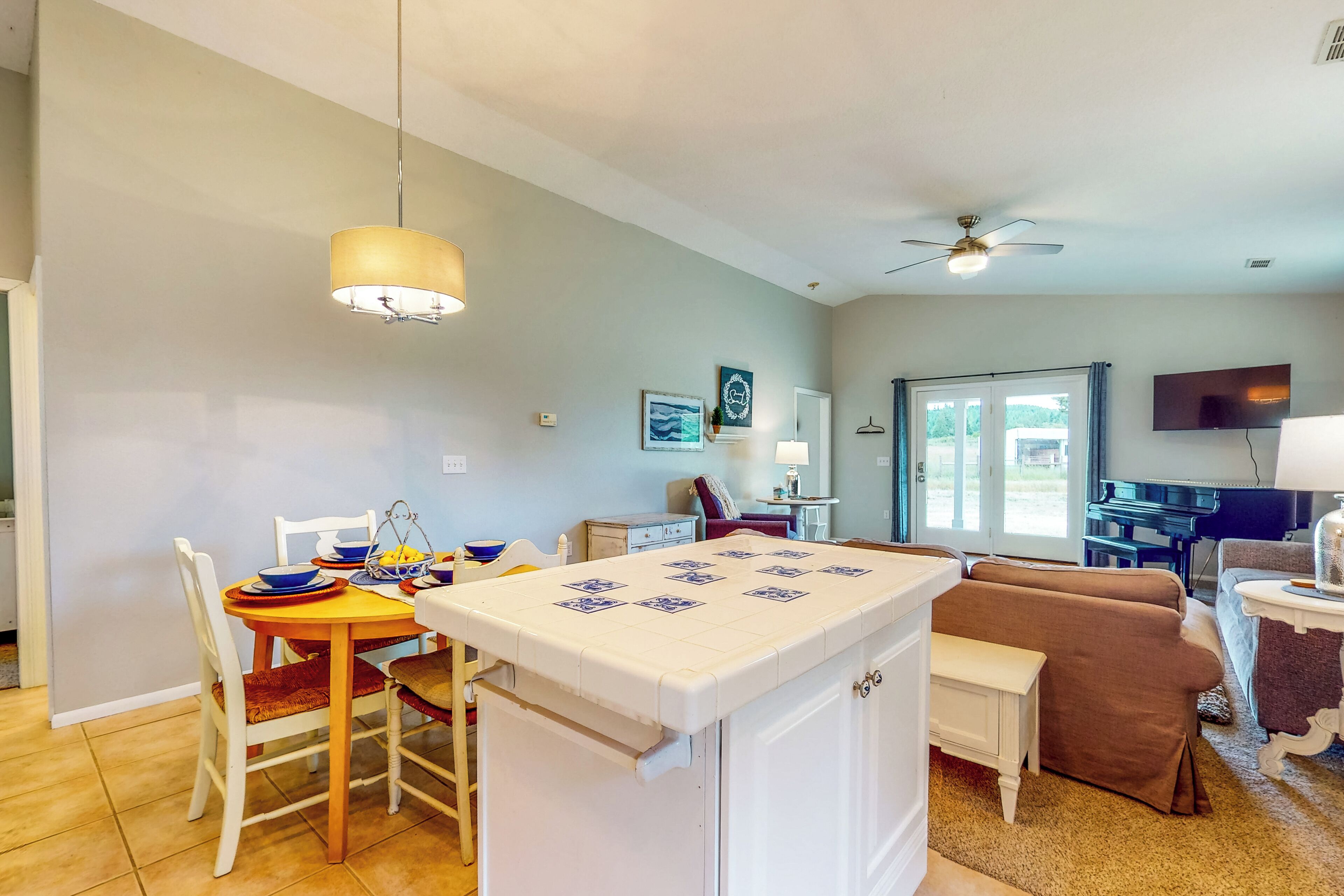 A compact living space with a dining area, kitchenette, and seating area.