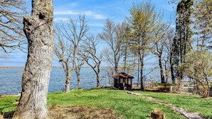 A park with a gazebo, a grassy area, and a body of water in the background. - 6BR Lakefront Estate w/ Private Piers & Patios (Ripon)