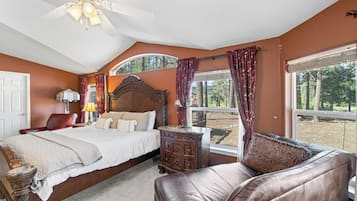 A bedroom with a bed, a dresser, a chair, and a window with curtains.