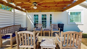 An outdoor patio with wooden furniture, a ceiling fan, and a view of the house. - Dairy Cottage w/ Scenic Views, Outdoor Grilling (Tylertown)