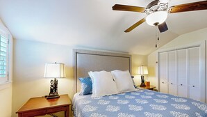 A bedroom with a bed, two bedside tables, a ceiling fan, and a wardrobe. - Windmill Trails Farm - Barn Loft and Dairy Cottage (Tylertown)