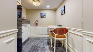 A hallway with a dining area featuring a table and chairs, a fire extinguisher, and artwork on the walls. - Nurse-ready Studio Retreat! 2 Mi to Dtwn Holyoke (Holyoke)