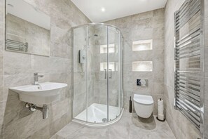 Shower, hair dryer, towels, shampoo