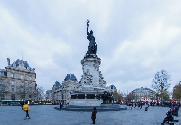 A public square with a central statue, surrounded by historic buildings. - AN IDEAL BLEND OF COMFORT, PARISIAN CHARM-JUST STEPS FROM PLACE DE LA RÉPUBLIQUE (Paris)