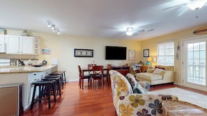 A compact living space with a kitchen, dining area, and seating area. - Ocean Whisper: 3  BR, 2  BA House in Crystal Beach, Sleeps 8 (Bolivar Peninsula)