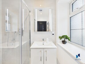 Shower, hair dryer, towels, soap