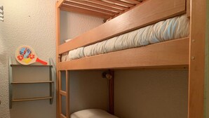 A bunk bed with a ladder, a shelf with a decorative item, and a pillow. - Bright studio 4 pers, balcony, close to slopes Pra-Loup 1600 (Pra-Loup)