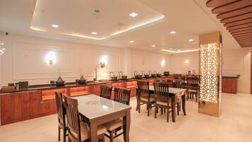 Una cocina moderna con muebles de madera, una isla central y un comedor con sillas de madera.