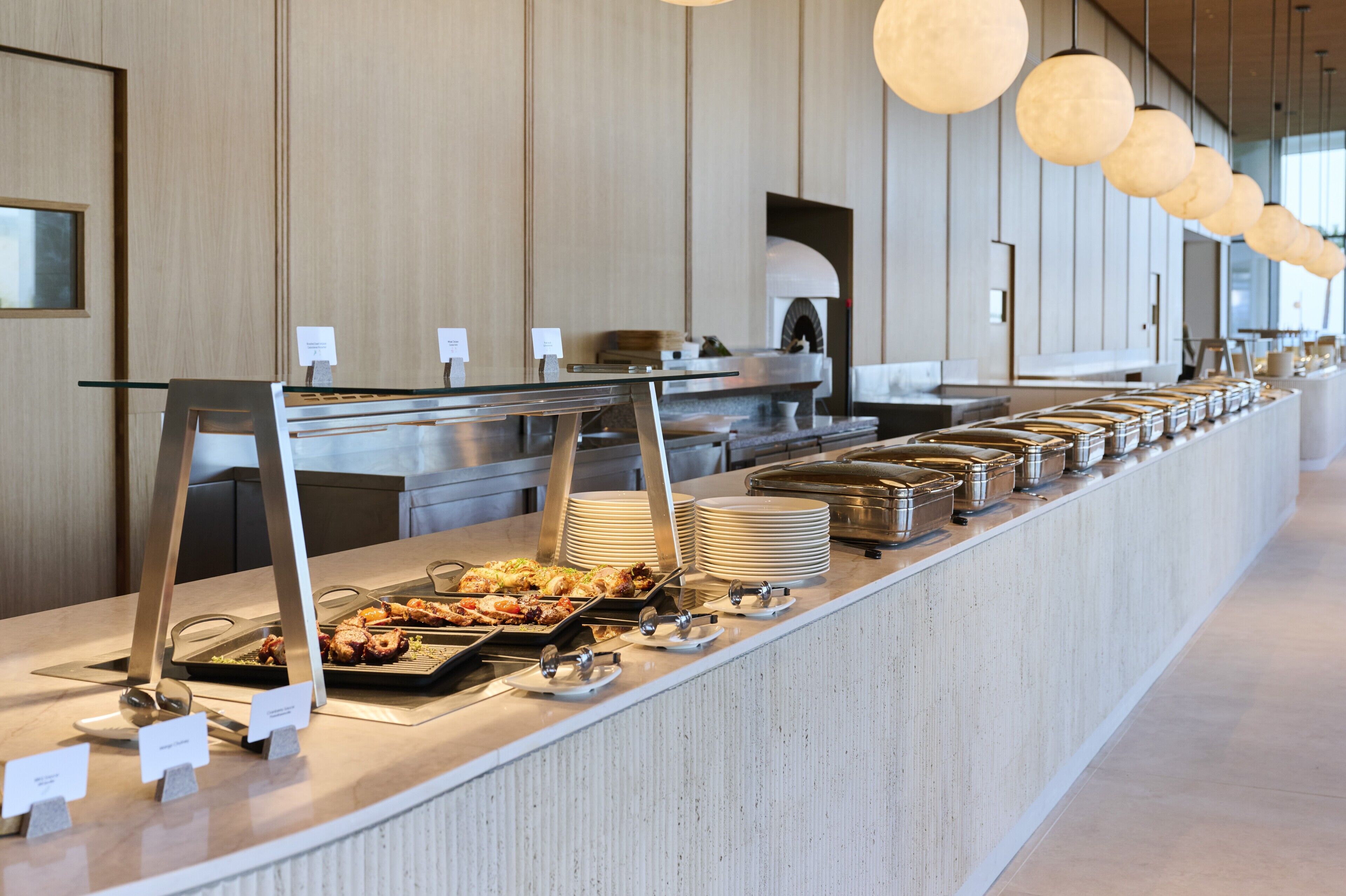 A buffet setup with various food items and serving utensils.