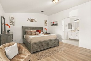 A bedroom with a large bed, a nightstand, a dresser, and a mirror. - 3BR Desert Escape , Pool, Views & Mini Golf (Desert Hot Springs)