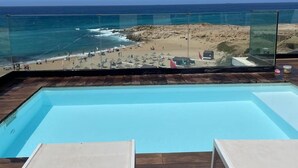 A pool with a view of a beach and ocean. - atico azul (Tangier)