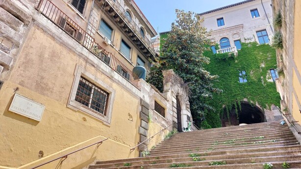 Una escalera que lleva a un edificio con un letrero que dice "VIA N. FRANCESCO DI PAOLA".
