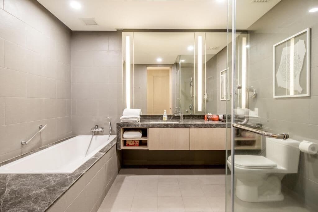 A modern bathroom with a bathtub, sink, and toilet.