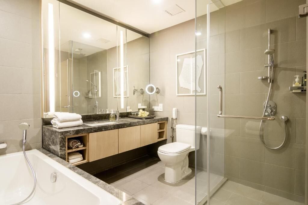 Separate tub and shower, hair dryer, slippers, towels