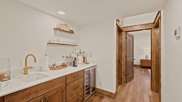 A modern kitchen with wooden cabinets, a white countertop, and a built-in oven.